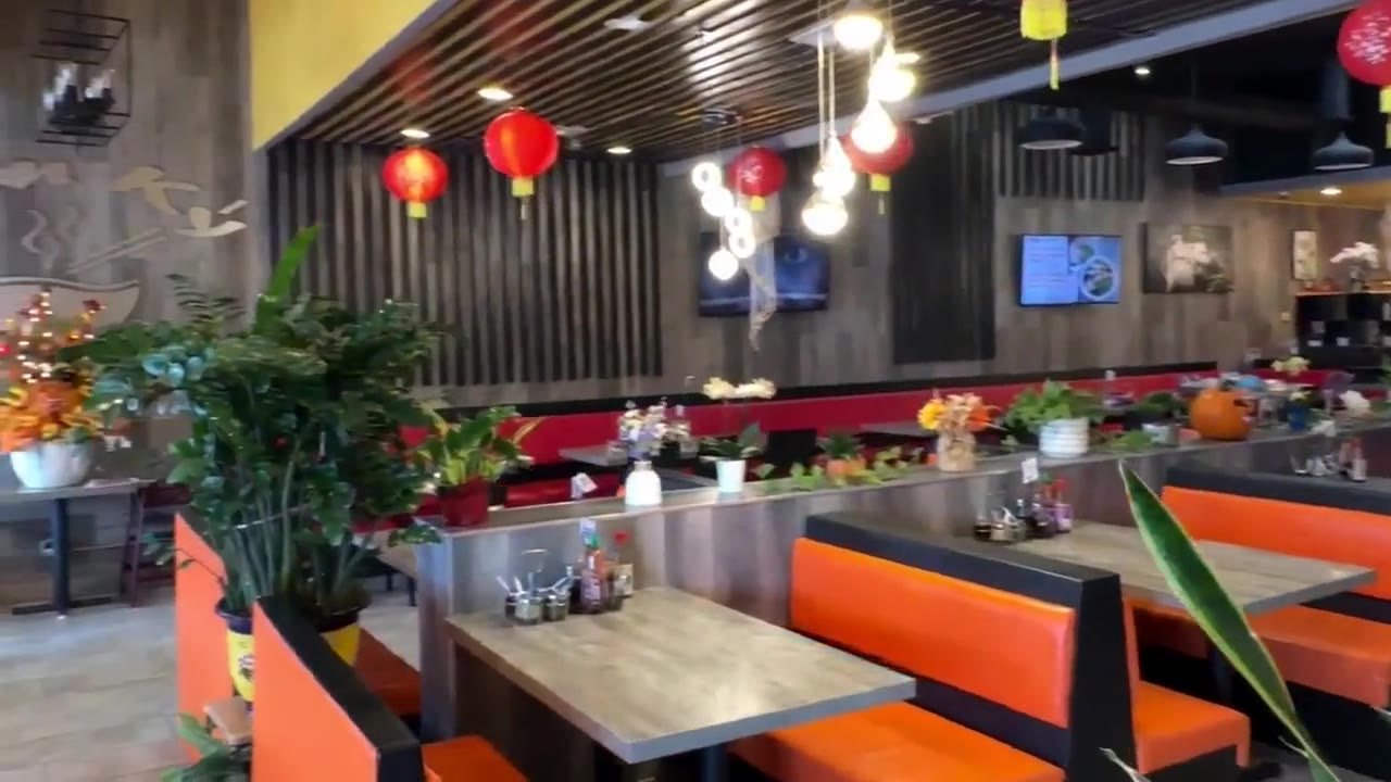 Inside Dìn Ký: orange booths, yellow walls and red lanterns